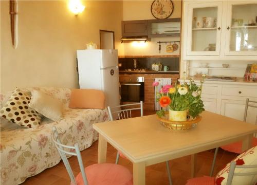 a kitchen and living room with a table with flowers on it at Villa Mont des Oliviers CITRA-8055LT-1805 e 1807 in Sanremo