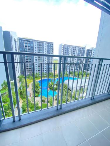 a balcony with a view of a swimming pool at NVilla Splashmania Gamuda Cove - Mayabay Residences in Banting