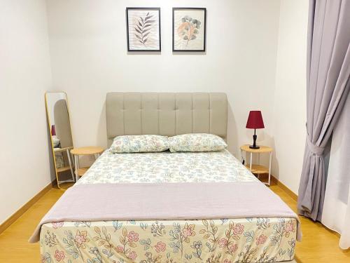 a bed in a bedroom with two pillows on it at NVilla Splashmania Gamuda Cove - Mayabay Residences in Banting