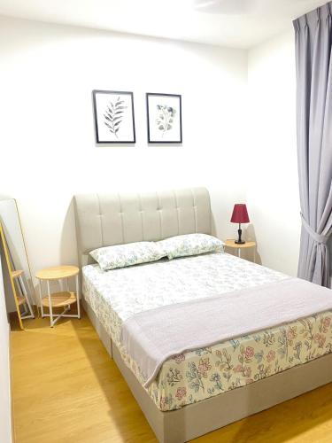 a bed in a white room with a bed frame at NVilla Splashmania Gamuda Cove - Mayabay Residences in Banting