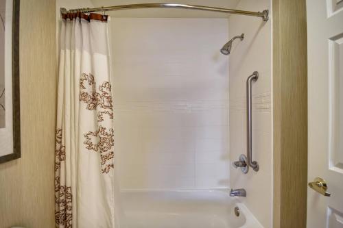 a bathroom with a shower and a white tub at Residence Inn by Marriott Dayton Beavercreek in Beavercreek