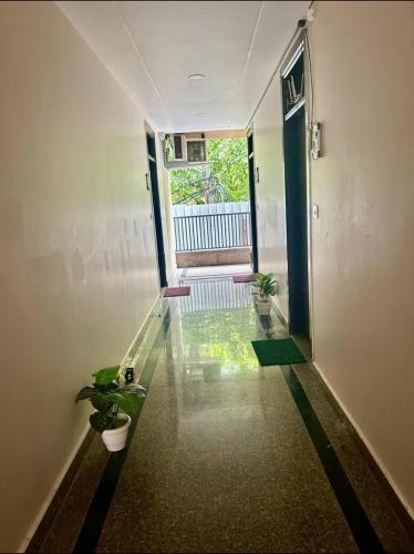 a hallway with a glass floor with potted plants at Chic Studio To Stay in South Delhi in New Delhi