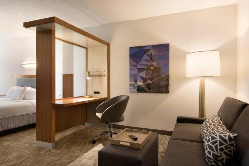 a hotel room with a bed and a desk and a chair at SpringHill Suites Ewing Township Princeton South in Ewing