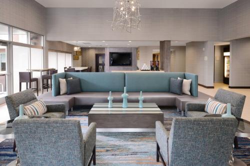 a living room with a couch and a table and chairs at Residence Inn by Marriott Dallas Plano The Colony in The Colony