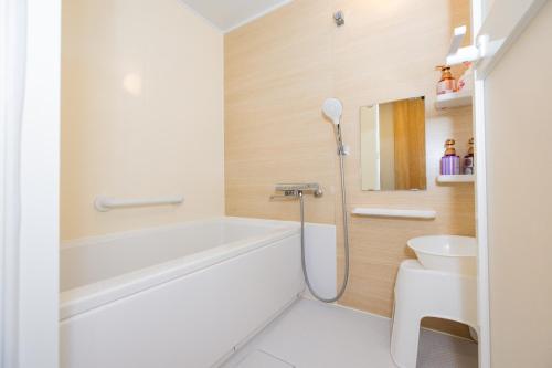 a bathroom with a shower and a toilet at Hotel Takasago in Kochi