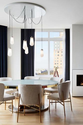 a dining room with a table and chairs at The Luxury Collection Hotel Manhattan Midtown in New York