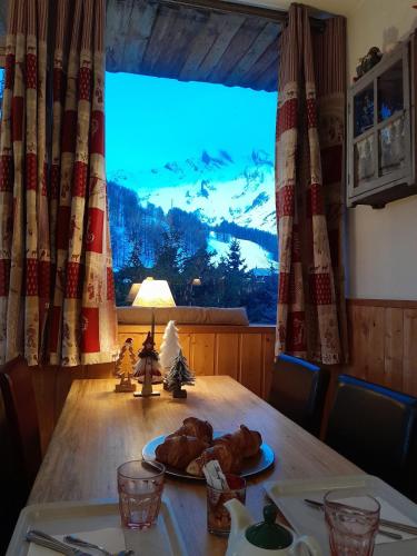 a table with a turkey on a plate on top of it at Hotel Restaurant La Source in La Foux