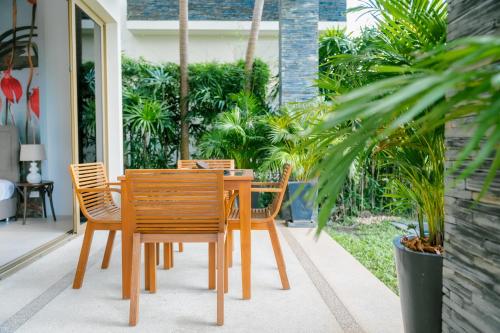 a wooden table and chairs on a patio at Seaview Villa Near Naithon Beach Phuket in Nai Thon Beach