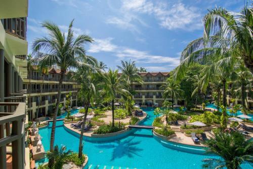 an aerial view of a resort pool with palm trees at Phuket Marriott Resort & Spa, Merlin Beach in Patong Beach