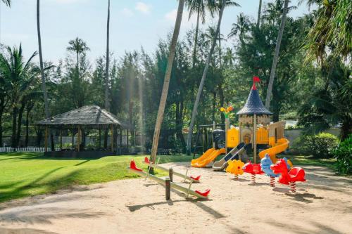 a playground in a park with a slide at Phuket Marriott Resort & Spa, Merlin Beach in Patong Beach