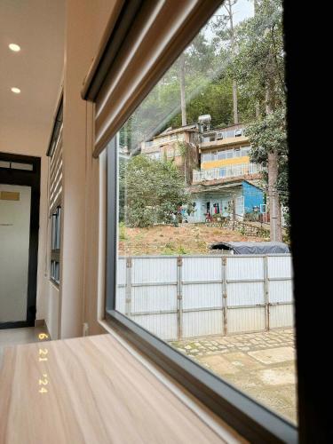 a window in a room with a view of a building at Sunflower Garden Homestay Đà Lạt in Xuan An