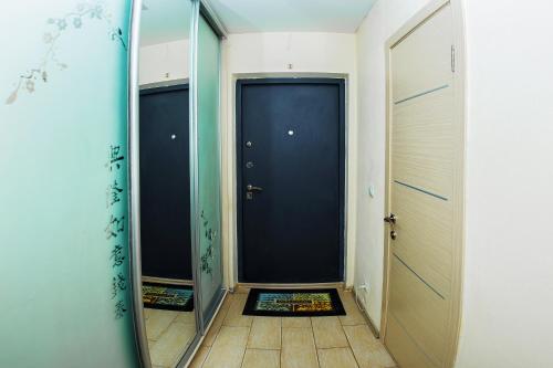 a hallway with two doors and a mirror at NSK-Kvartirka, Apartment Gorskiy 75 in Novosibirsk