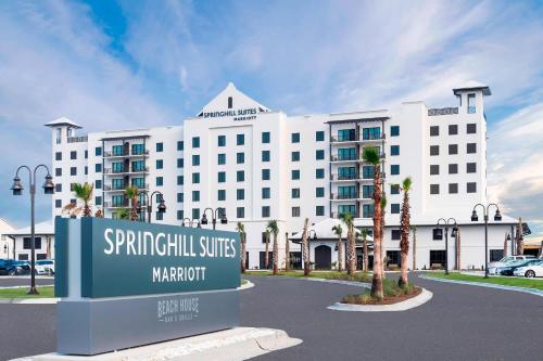 a large white building with a sign in front of it at SpringHill Suites by Marriott Navarre Beach in Navarre