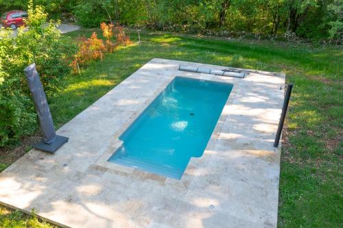 une piscine vide dans une cour dans l'établissement Magnifique longère en pierre du Lot Piscine Privée, à Vaylats