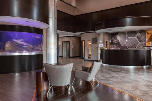 a lobby with two chairs and a fish tank at SpringHill Suites by Marriott Waco Woodway in Woodway