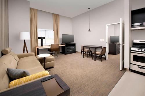a living room with a couch and a table at Residence Inn by Marriott Denver Airport/Convention Center in Denver