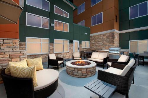 a patio with chairs and a fire pit in front of a building at Residence Inn by Marriott Denver Airport/Convention Center in Denver