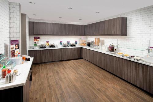 a large kitchen with wooden floors and a counter top at Residence Inn by Marriott Denver Airport/Convention Center in Denver