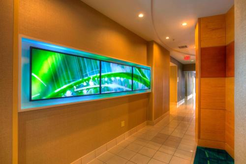 a large flat screen tv on a wall in a hallway at SpringHill Suites by Marriott - Tampa Brandon in Tampa