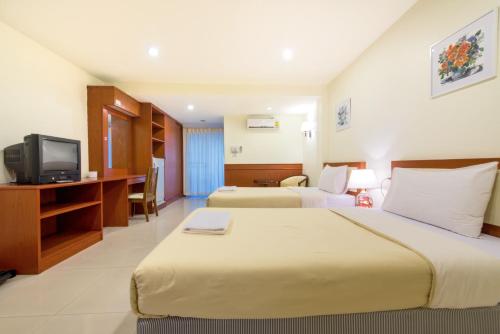 a hotel room with two beds and a television at Nuntiya Terrace in Udon Thani