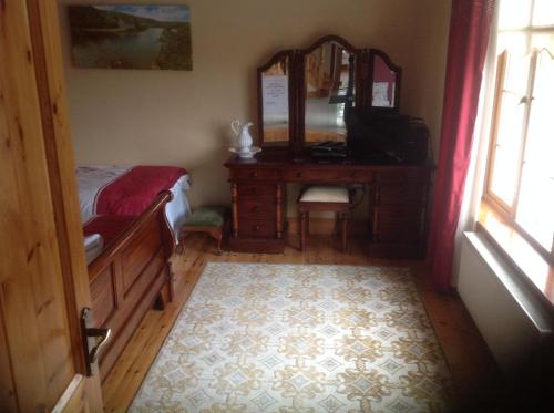 a bedroom with a dresser and a mirror and a bed at Country House B@b in New Twopothouse Village