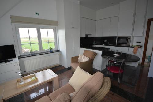 a living room with a couch and a table at PS Orion in Wenduine