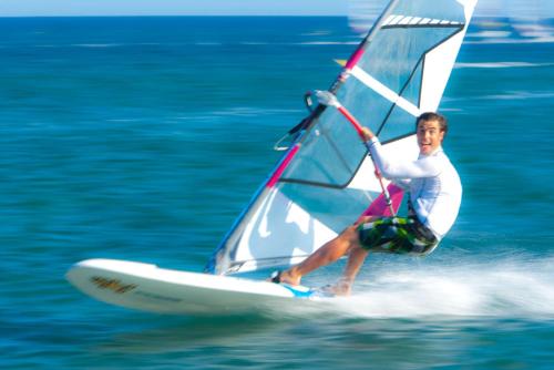 a man riding a sail board on the water at Prasonisi Club in Kattavía