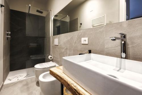 a bathroom with a sink and a toilet at Boccaccio Apartment in Ravenna