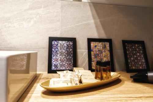 a wooden table with a tray with stained glass at Boccaccio Apartment in Ravenna