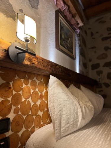 a bedroom with a bed with a wooden headboard at Castel Madonna in San Martino di Castrozza