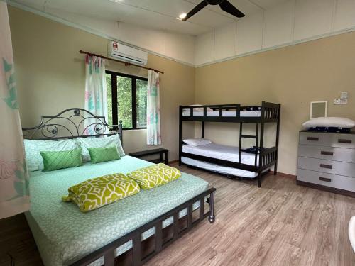 a bedroom with two bunk beds and a window at Mountain Lodge, Radiant Janda Baik in Bentong