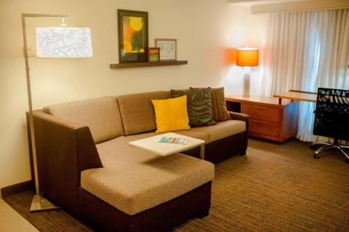 a living room with a couch and a table at Residence Inn Cincinnati Airport in Erlanger