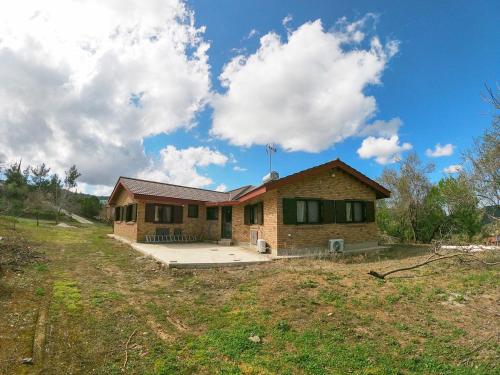 a house in a field with a sky at Orama Mountain Villa Farmakas in Nicosia
