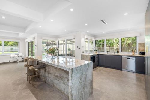 a large kitchen with a large marble counter top at Exquisite Oasis Family Retreat in Perth