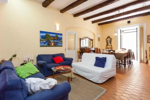 a living room with blue couches and a table at Bed and Breakfast Adelberga in Salerno