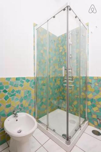 a bathroom with a shower with a toilet and a sink at Bed and Breakfast Adelberga in Salerno