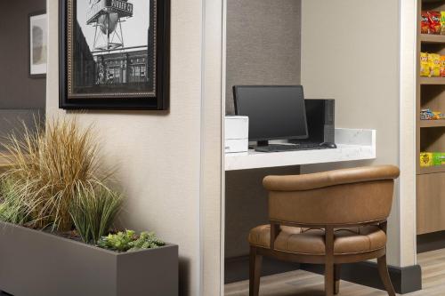 a chair sitting in front of a desk with a computer at Residence Inn Denver South/Park Meadows Mall in Centennial