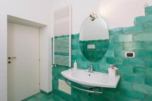 a bathroom with a sink and a mirror at Bed and Breakfast Adelberga in Salerno