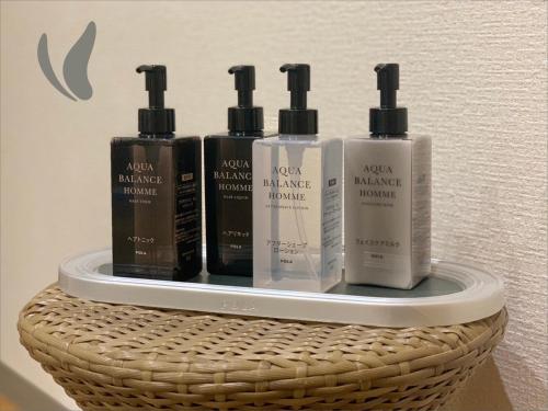 a shelf with four bottles of hair products on it at Hotel Hokke Club Fukuoka in Fukuoka