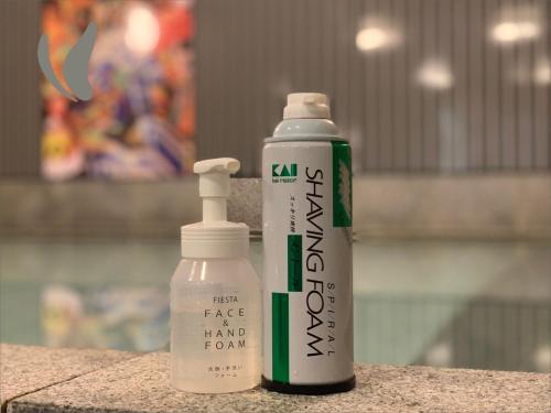 two white and green bottles sitting next to each other at Hotel Hokke Club Fukuoka in Fukuoka