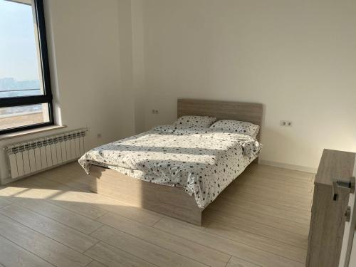 a bedroom with a bed with a comforter on it at Two bedroom MEGA MALL Hills Sports & Spa adjacent120Meter13Ff in Yerevan