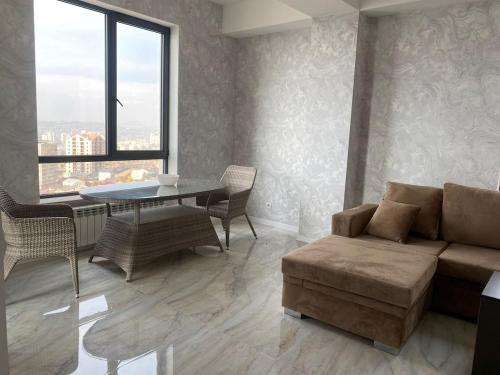 a living room with a couch and a table at Two bedroom MEGA MALL Hills Sports & Spa adjacent120Meter13Ff in Yerevan