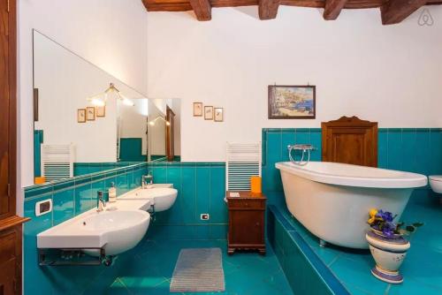 a bathroom with three sinks and a large tub at Bed and Breakfast Adelberga in Salerno