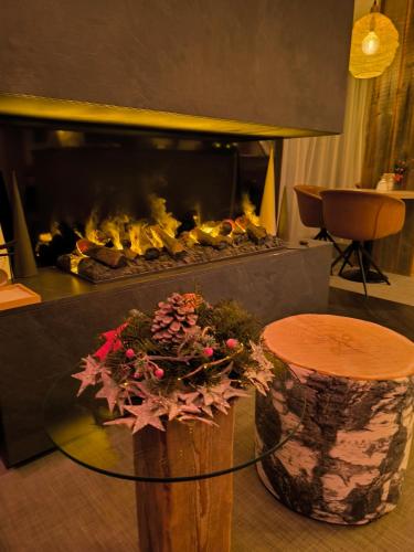 a fireplace with a glass table and a fire place at Safranberg Hotel & Sauna in Ulm