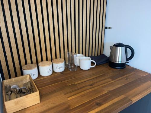 a wooden counter with cups and appliances on it at Studio in Glenorchy in Glenorchy