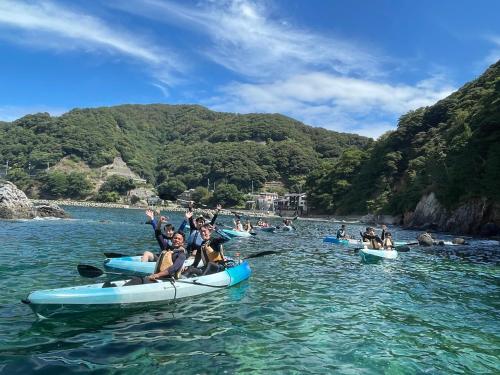 a group of people on kayaks in the water at 湖上館パムコ in Wakasa