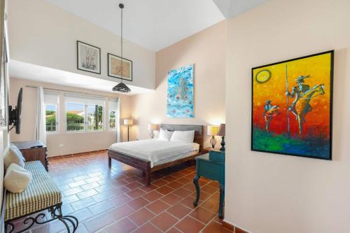 a bedroom with a bed and a painting on the wall at Villa De Palma -Oceanfront community w generator in Sabana