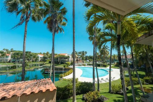 a view from the balcony of a resort with palm trees at Villa De Palma -Oceanfront community w generator in Sabana