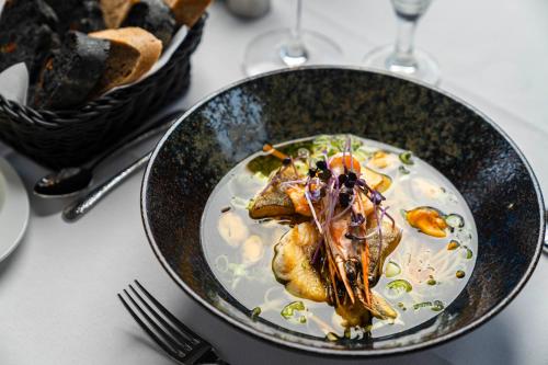 a plate of food with fish on a table at meergut HOTELS in Kühlungsborn