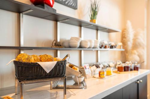 a counter with a basket of food on a table at meergut HOTELS in Kühlungsborn